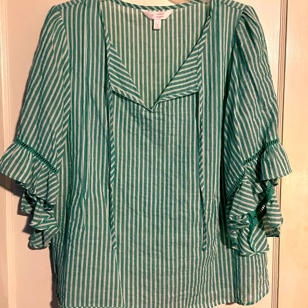 Cute lightweight summer top. Seersucker fluted sleeve top with tie at neckline.